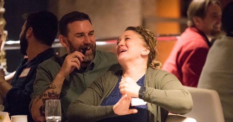 Couple laughing at murder mystery dinner theatre