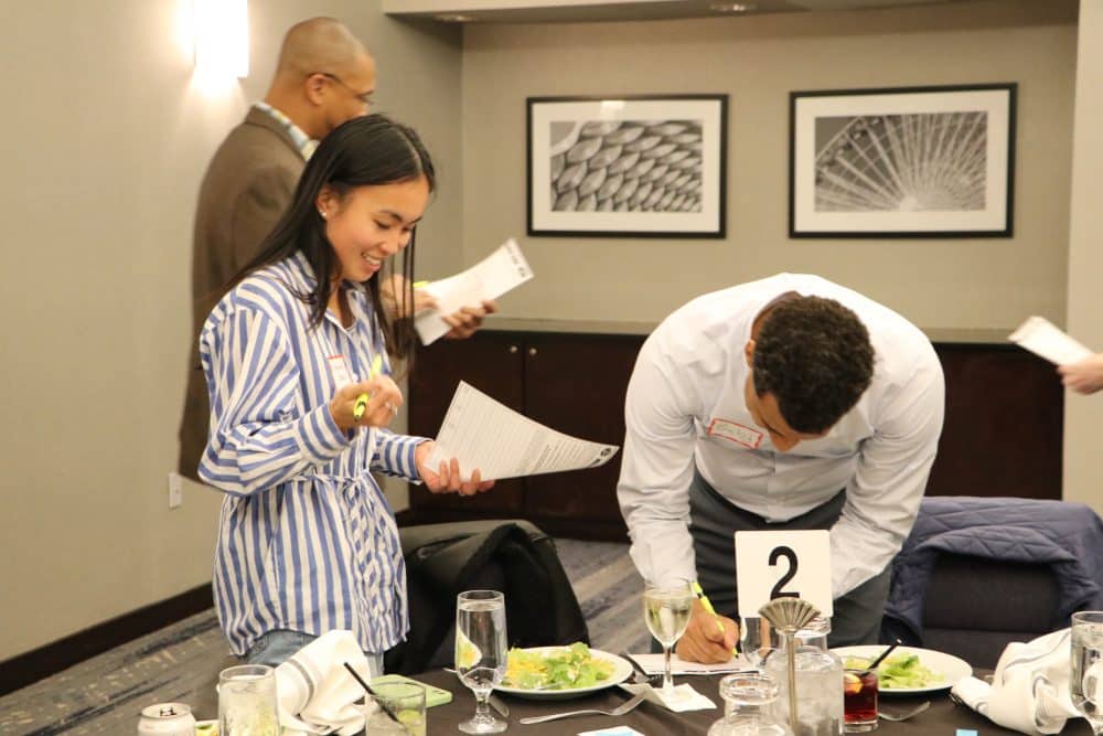 Guests at a Houston murder mystery show interacting during the game