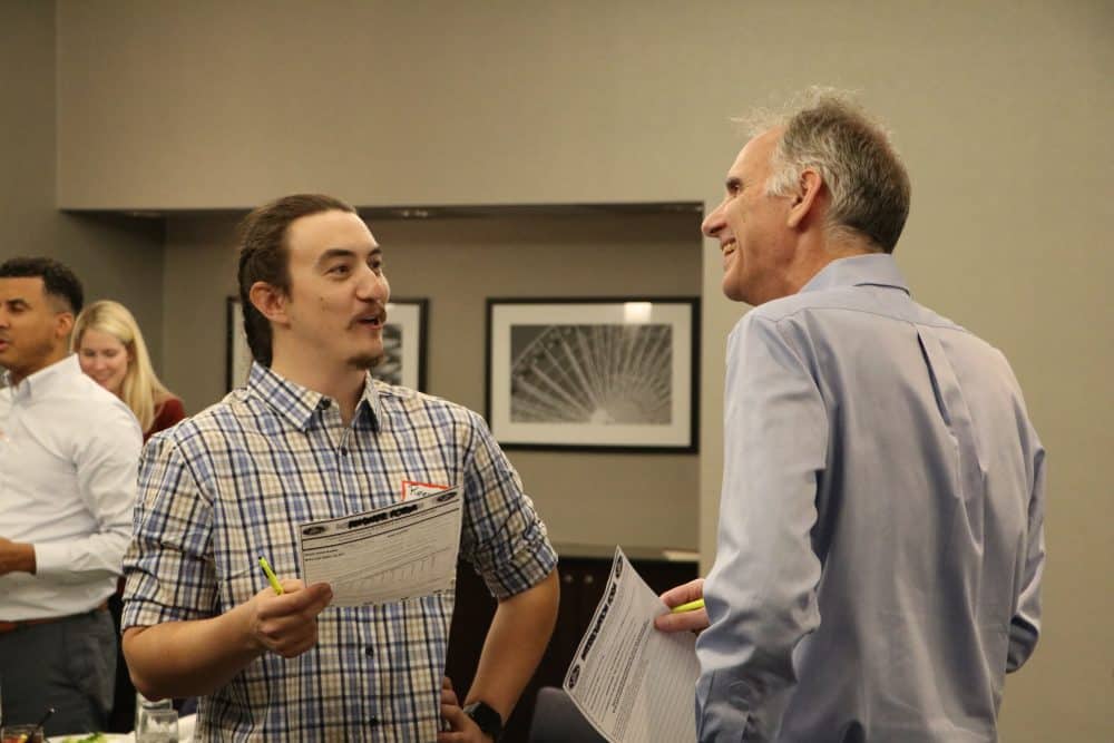 Lively conversation between guests during interactive mystery show