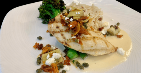 Tuscan chicken with a savory blend of herbs and spices served with seasonal vegetables.