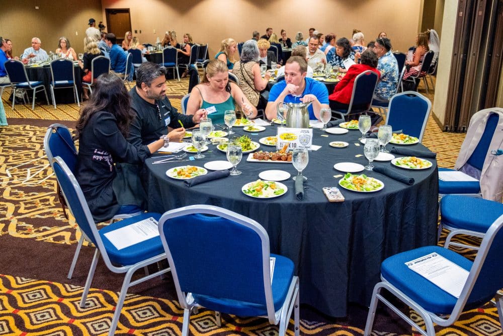 Guests enjoying dinner while engaging in a corporate murder mystery event at The Dinner Detective in Lexington, KY.