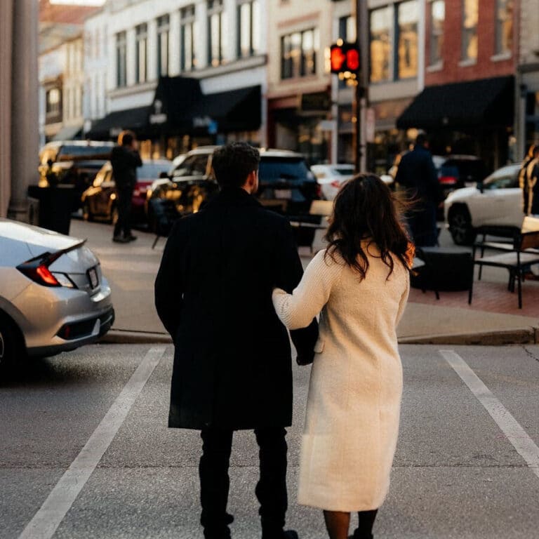 Couple enjoying a romantic date night stroll through downtown Lexington KY near The Dinner Detective murder mystery dinner theater