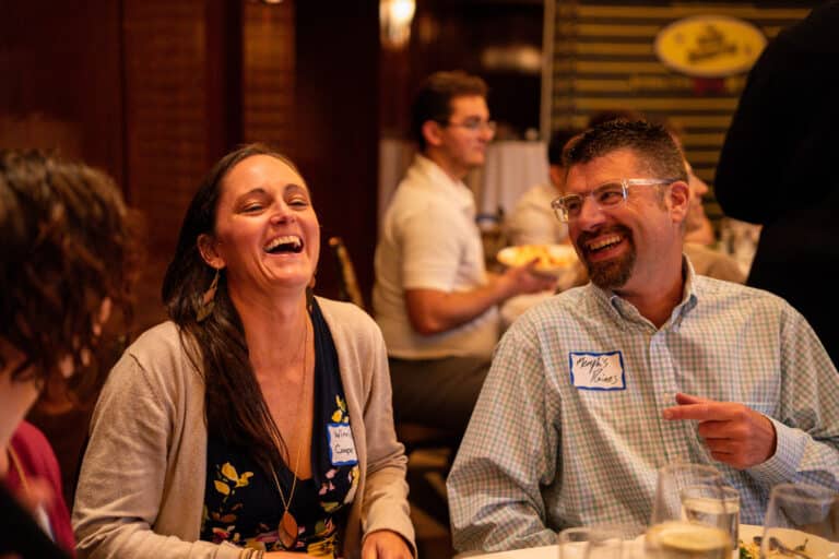 Couple laughing together at dinner during a fun date night experience in Lexington, KY