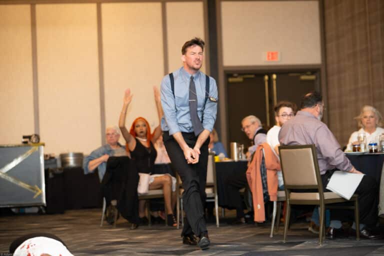 Guests laughing during a Halloween-themed Dinner Detective show in Lexington