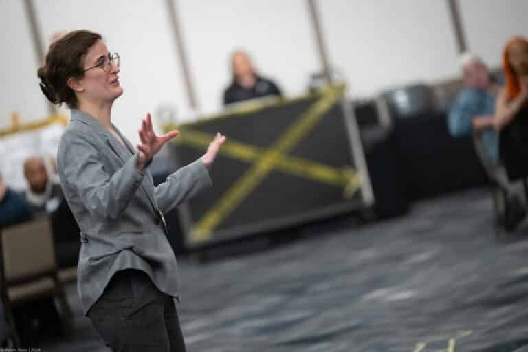 Sleuth hostess addresses the room during a Lexington Dinner Detective show as guests look onSleuth hostess addresses the room during a Lexington Dinner Detective show as guests look onSleuth hostess addresses the room during a Lexington Dinner Detective show as guests look onSleuth hostess addresses the room during a Lexington Dinner Detective show as guests look onSleuth hostess addresses the room during a Lexington Dinner Detective show as guests look on