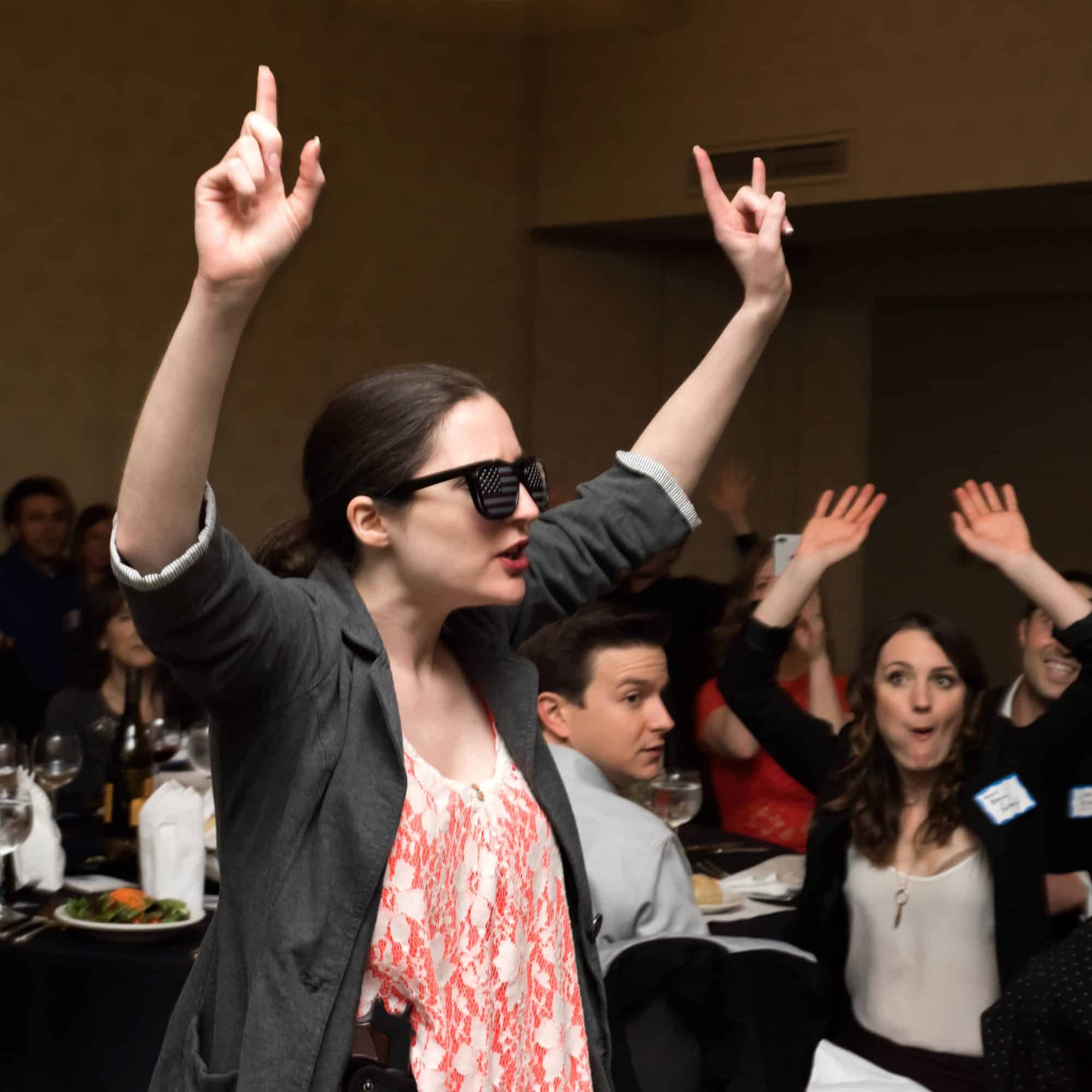 Guests interacting and solving a murder mystery during The Dinner Detective show in Louisville, KY.