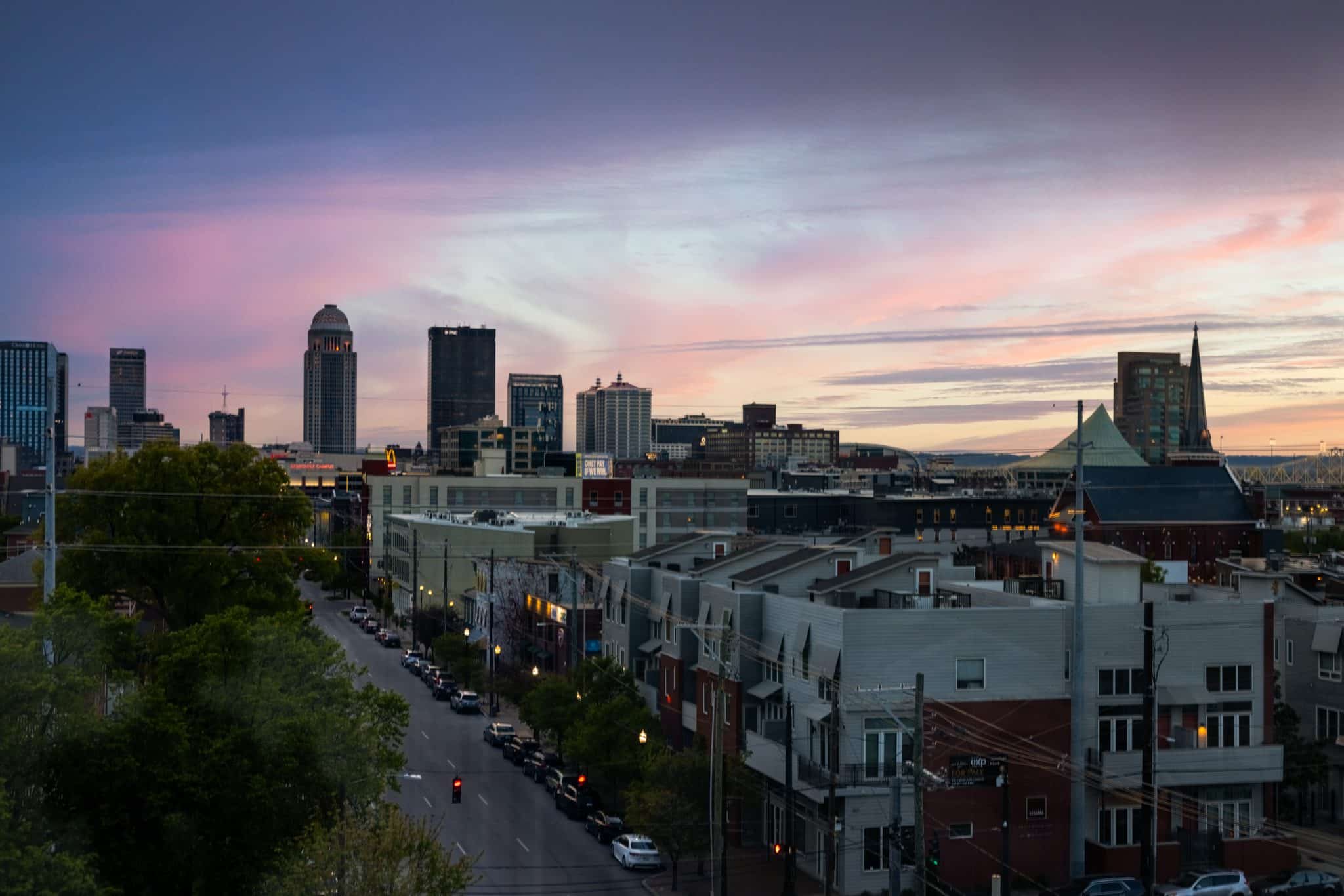 Panoramic view of the Louisville skyline at dusk as seen from the NuLu neighborhood rooftop.