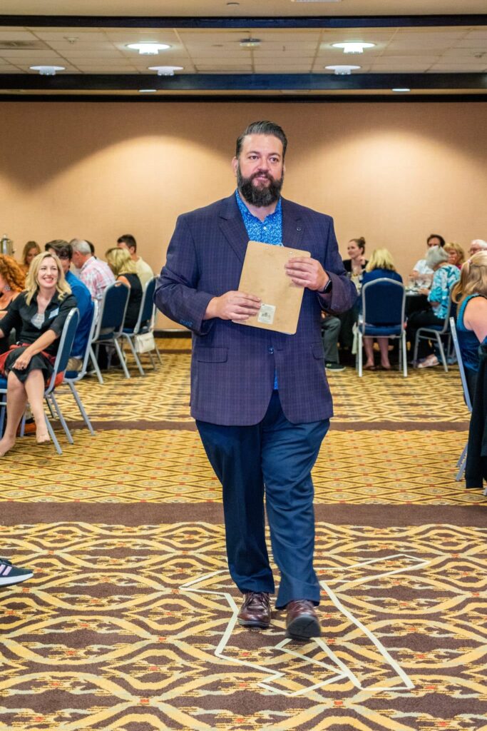 Host walking through crowd during Louisville murder mystery dinner show