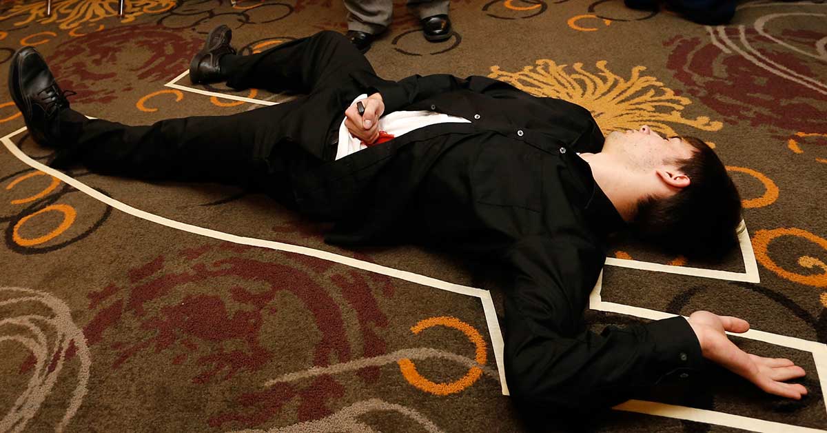 Murder mystery dinner event actor playing dead on floor
