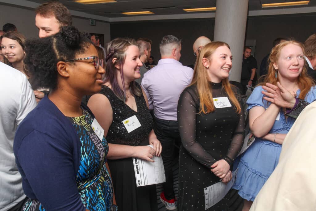 Guests laugh and listen during the interrogation reception at an interactive dinner show in Salt Lake City