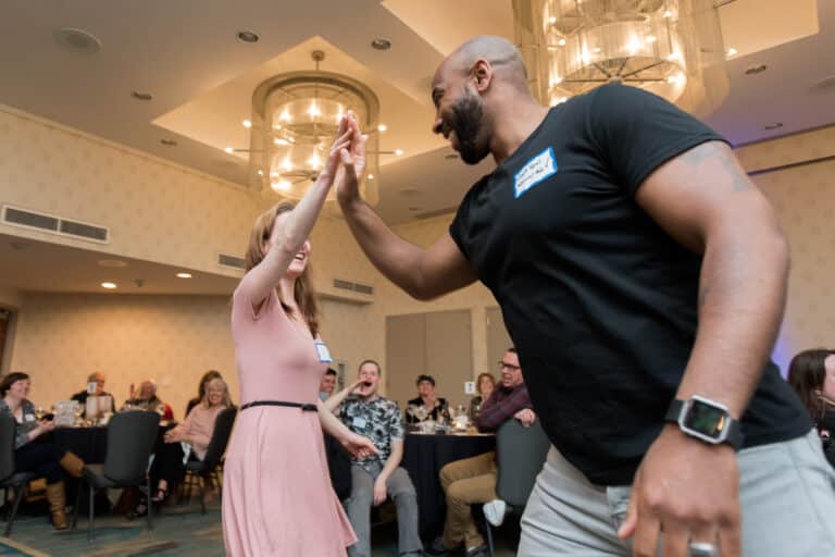 A couple laughing together while solving a mystery at The Dinner Detective, a top choice for interactive San Francisco date night ideas.