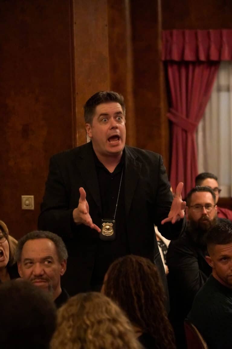 Detective actor performs during Seattle murder mystery dinner show