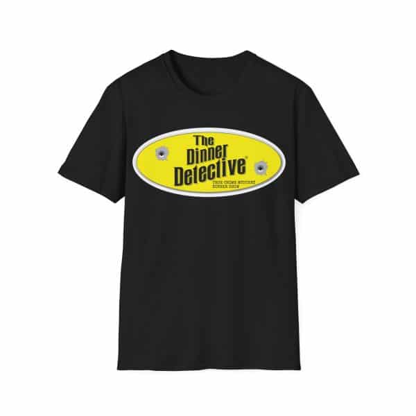The Unisex Softstyle T-Shirt in black features a yellow oval logo with The Dinner Detective centered and two discreet bullet hole graphics, along with the phrase Americas Largest Interactive Murder Mystery Dinner Show.